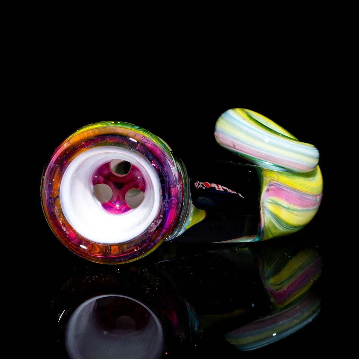 Colorful pastel rainbow glass pipe with spiral design on black reflective surface