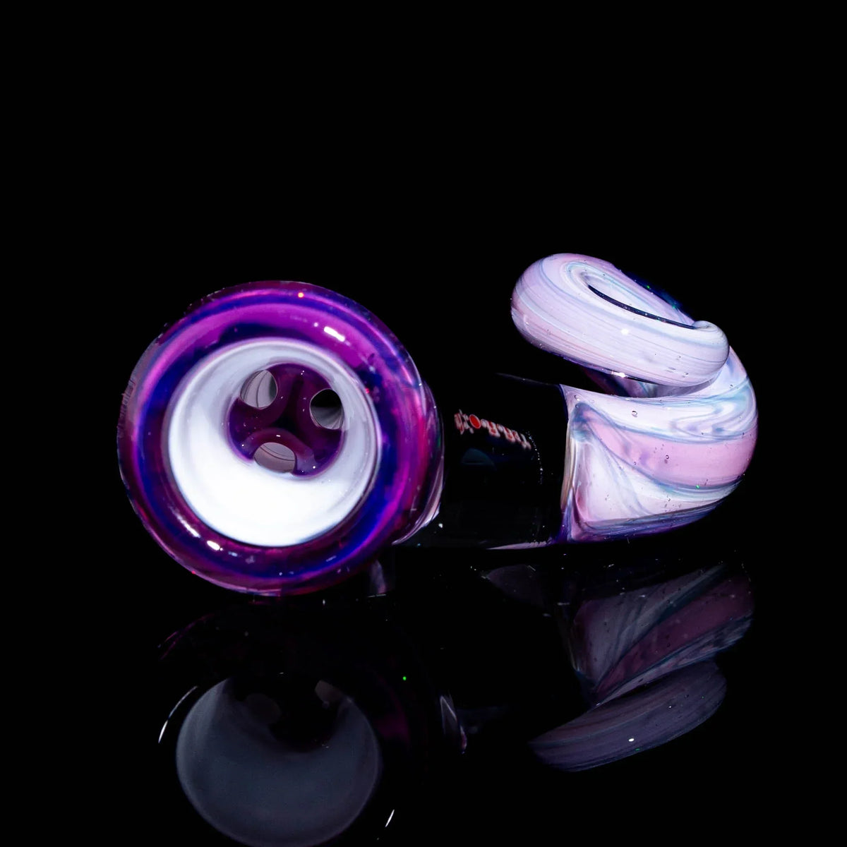 Purple and white glass slide with swirled medley design, displayed on black background