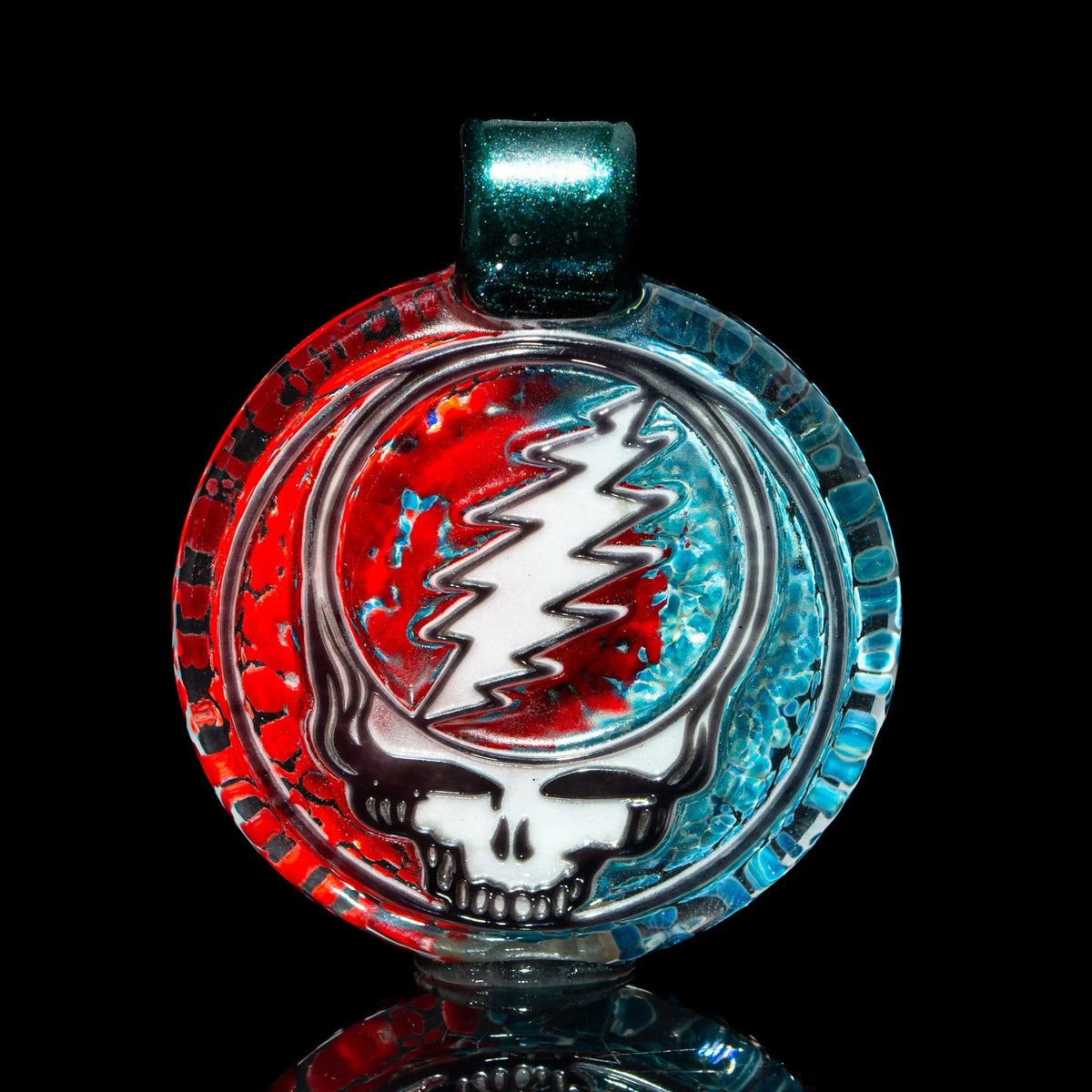 Red and blue glass pendant featuring a skull with a lightning bolt design