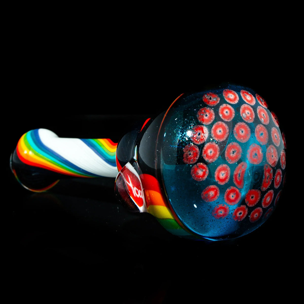Hand-blown glass pipe with rainbow linework and colorful patterned bowl on black background