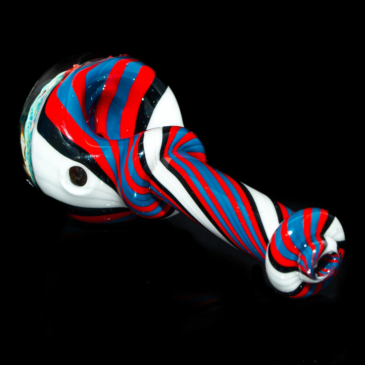 Red, blue, and white striped glass pipe with twisted spoon design on black background