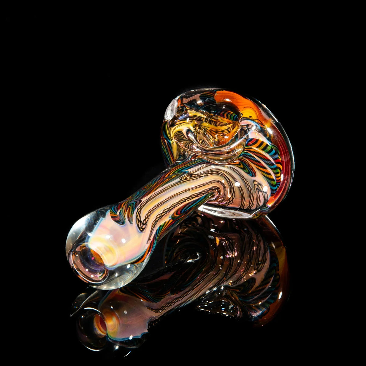 Colorful hand-blown glass pipe with rainbow cane design on black background