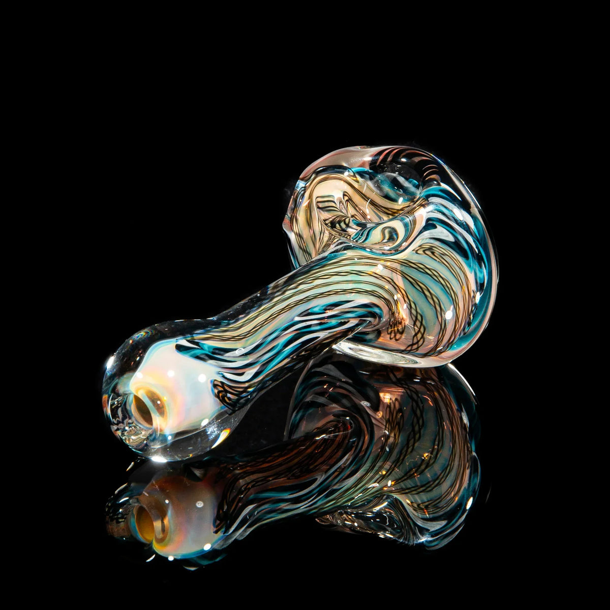 Hand-blown glass pipe with black, blue, and white cane lattice design on black background
