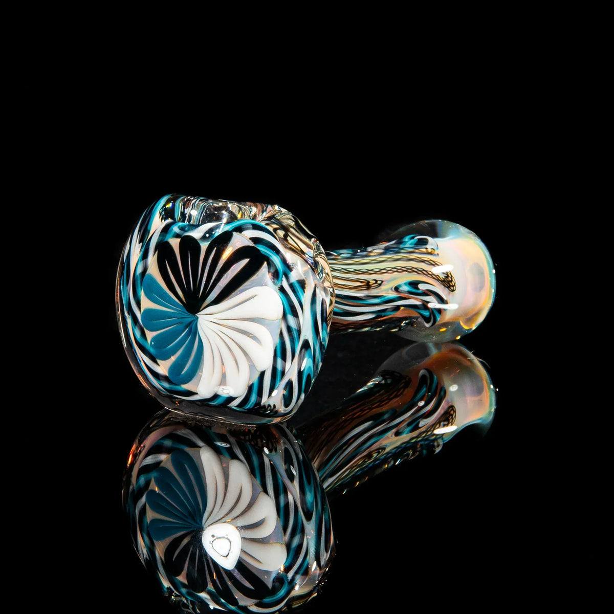 Black, blue, and white hand-blown glass spoon pipe with intricate cane patterns