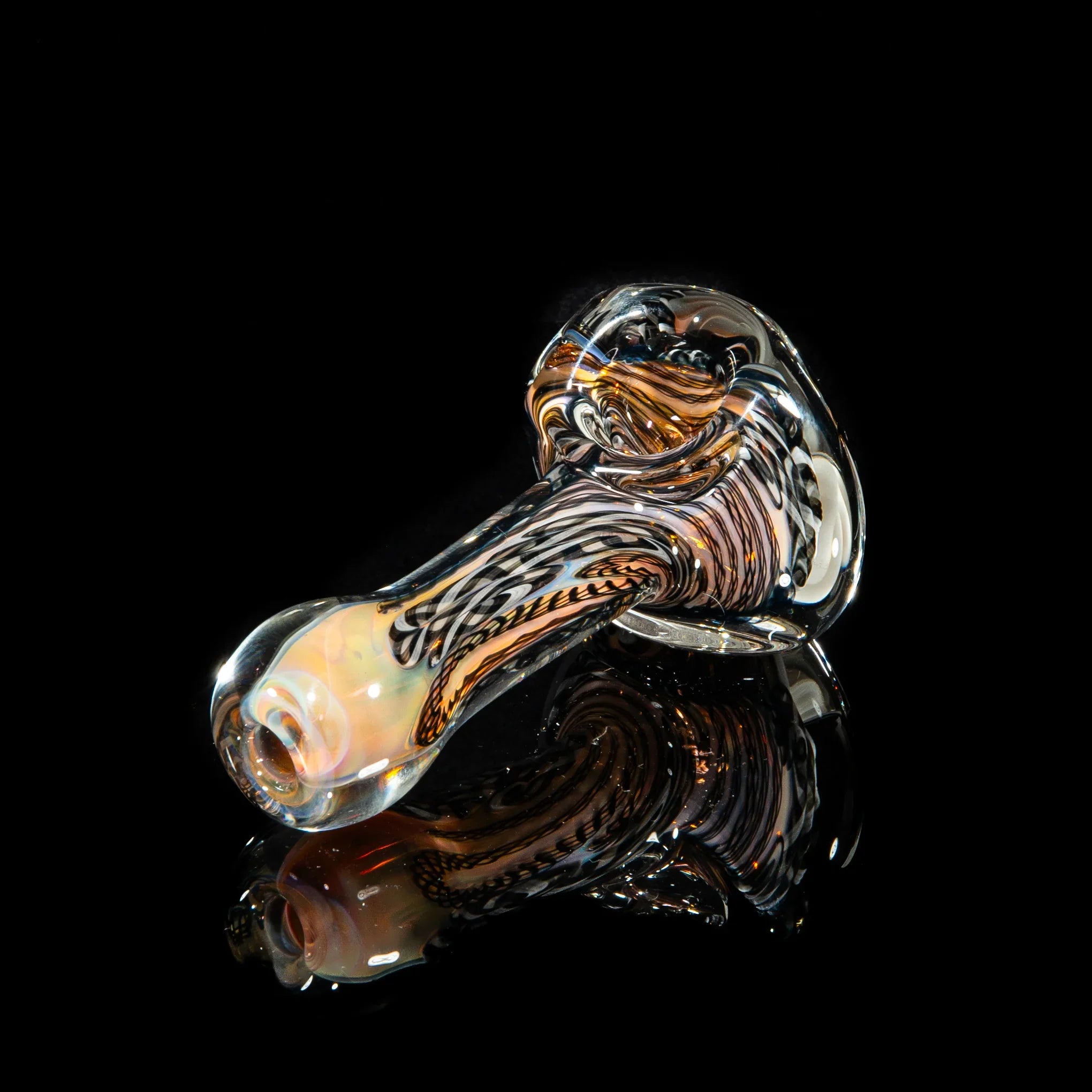 Handblown glass pipe with black, white, and gray swirled patterns on a black background.