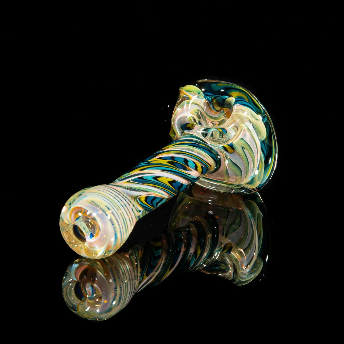 Handblown glass spoon pipe with blue, teal, and yellow swirl flower design on black background