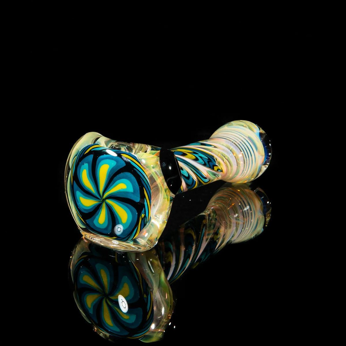 Hand-blown glass spoon pipe with blue, teal, and yellow flower design on black background