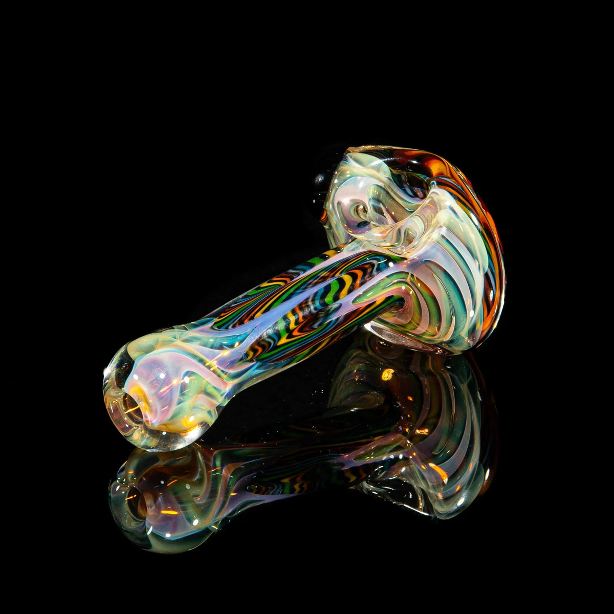Handcrafted glass spoon pipe with colorful brown, orange, and yellow flower design on black background