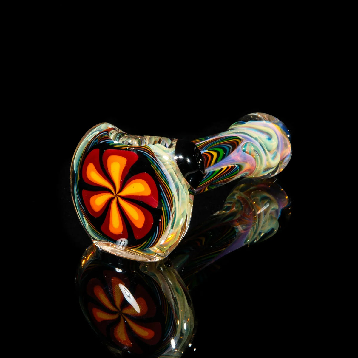 Colorful glass hand pipe with orange and yellow flower design on black background