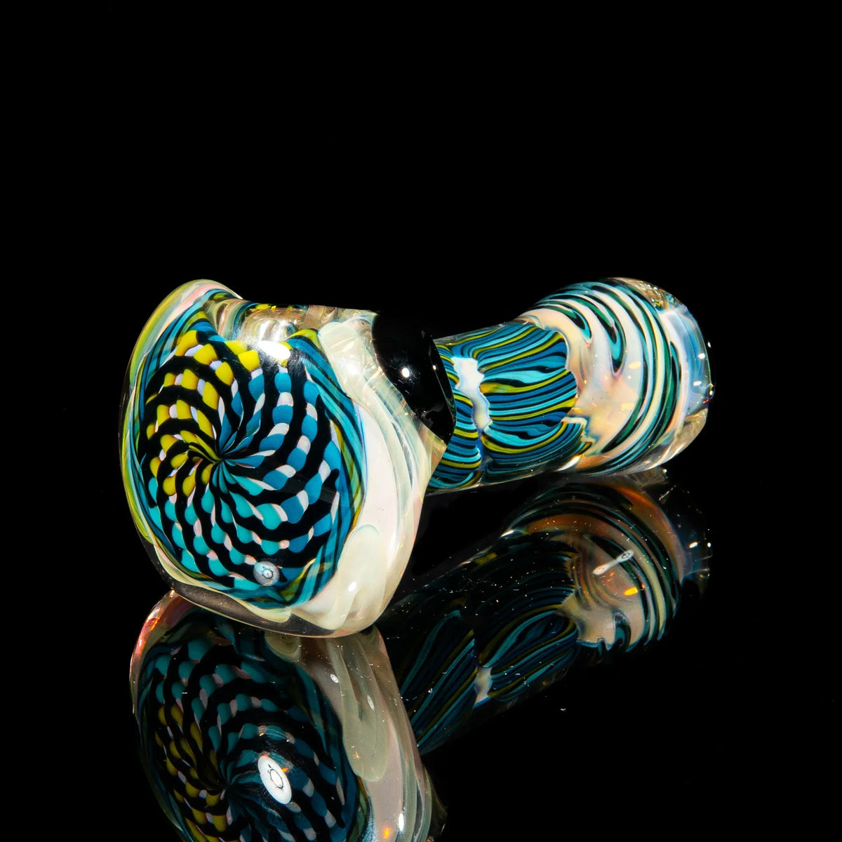 Colorful glass hand pipe with chartreuse, teal, and blue reticello pattern on black background