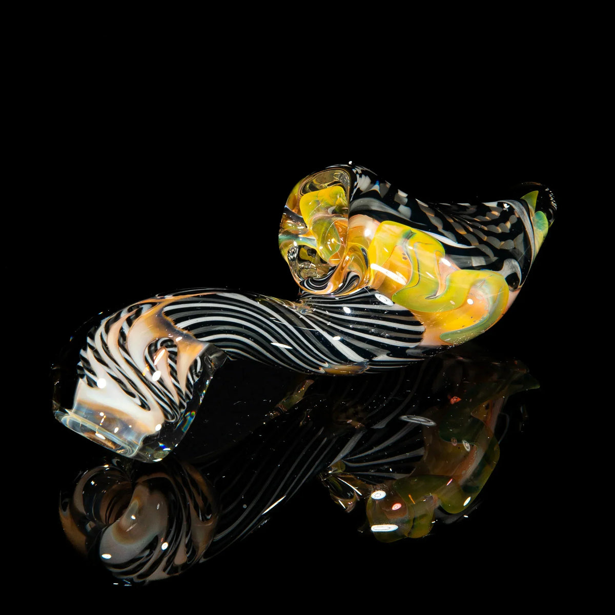 Gray, white, and black reticello glass sherlock pipe with yellow accents on black background