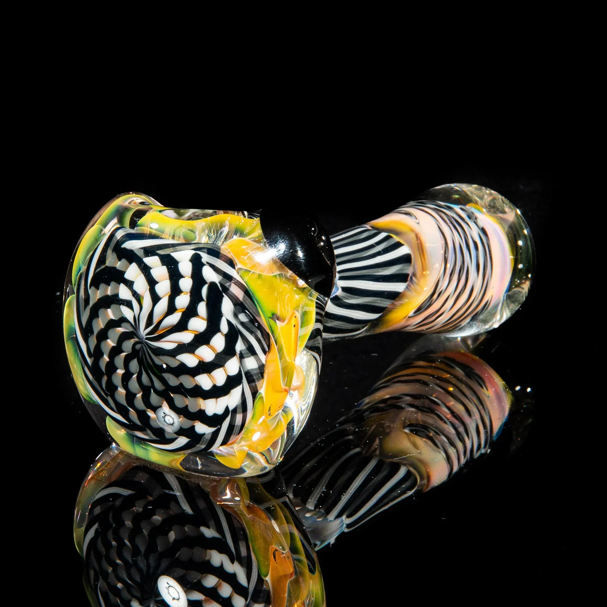 Gray, white, and black reticello glass spoon pipe with vibrant swirling patterns