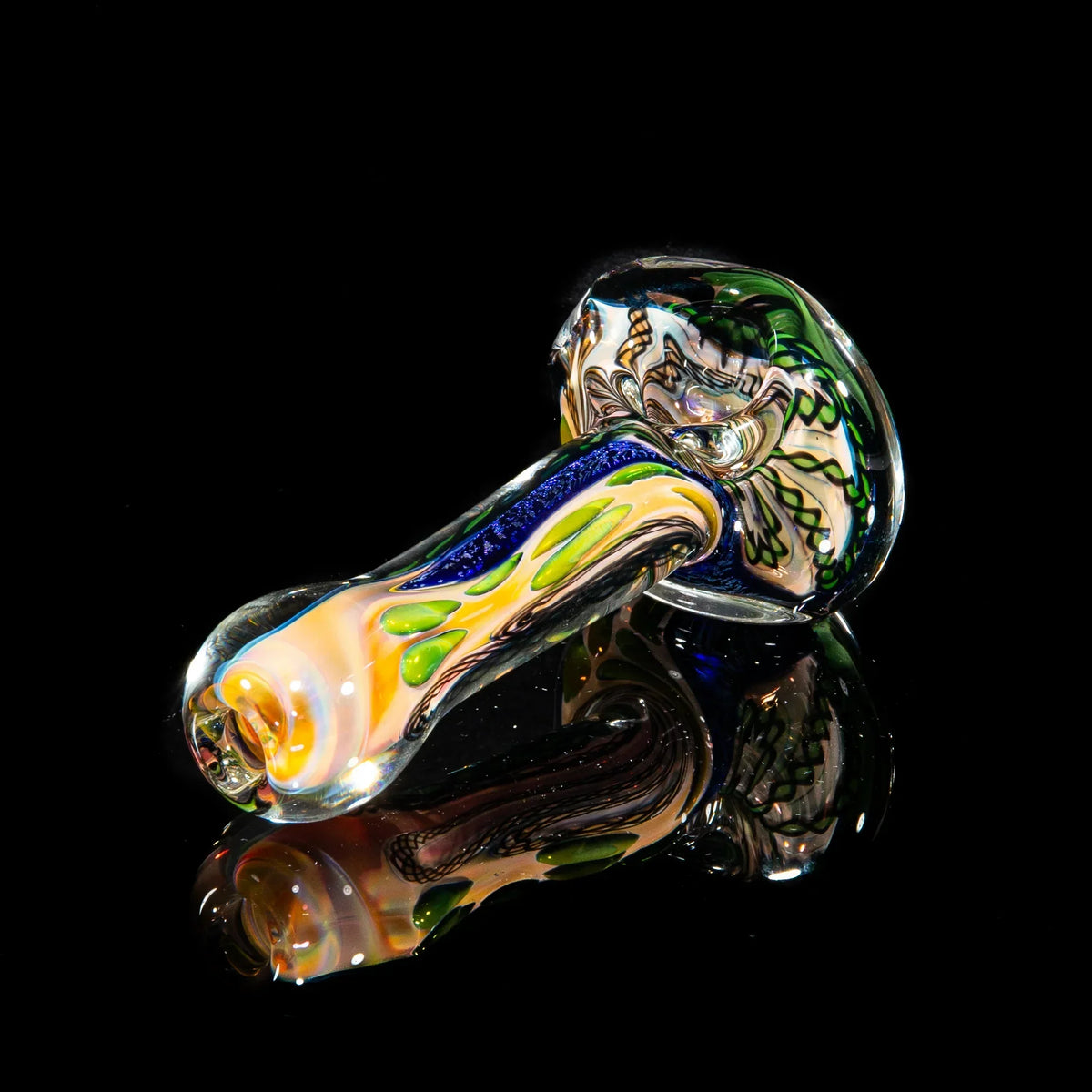 Hand-blown glass spoon pipe with green and blue dichroic strip, displayed on black background.