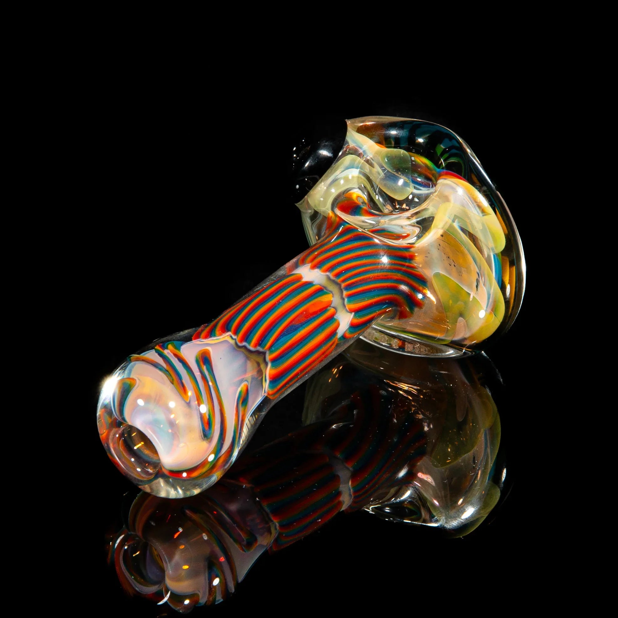 Colorful reticello hand-blown glass smoking spoon pipe with green, yellow, and blue accents