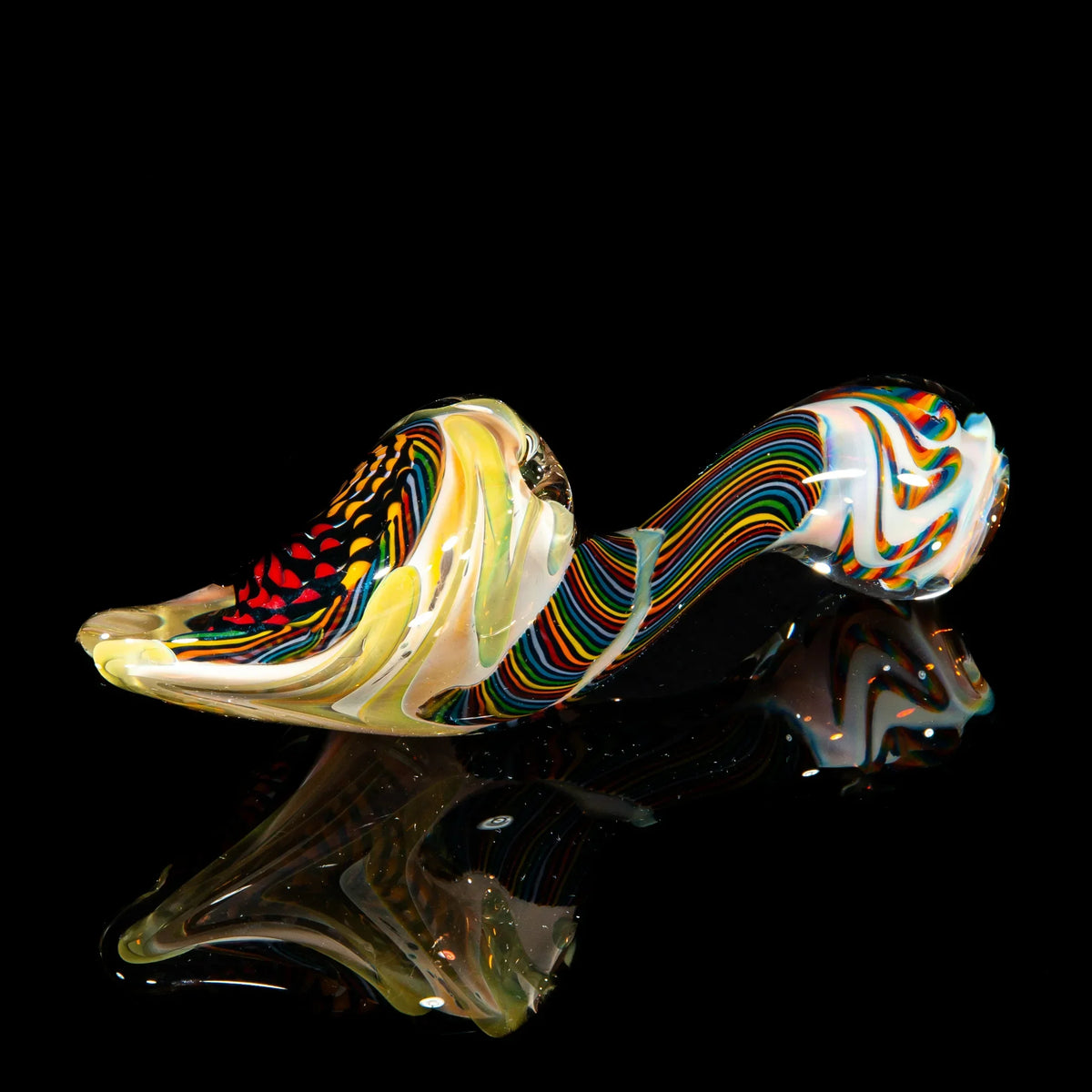 Handblown glass sherlock pipe with orange, yellow, brown reticello patterns on black background