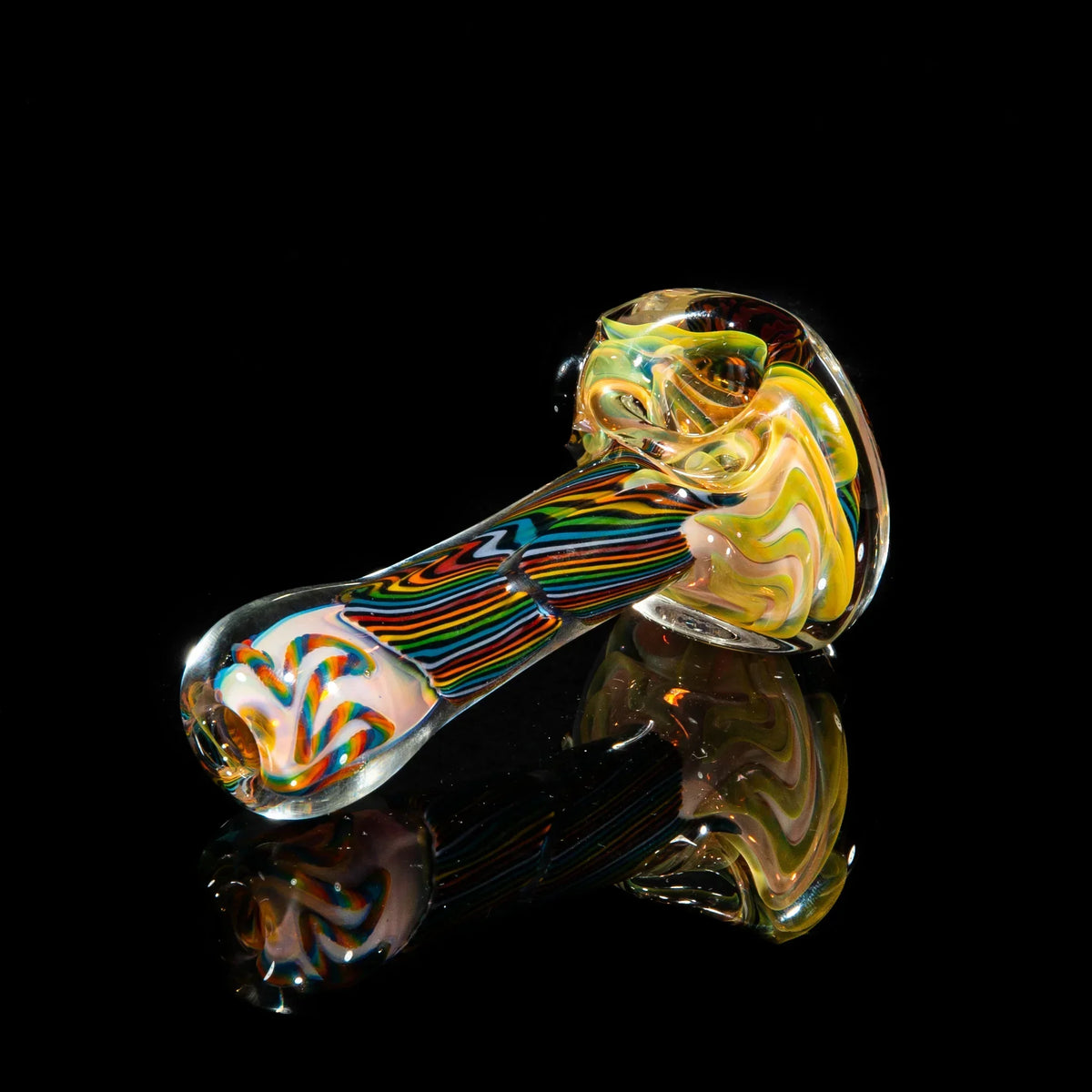 Colorful reticello glass hand pipe with orange, yellow, and brown swirling patterns