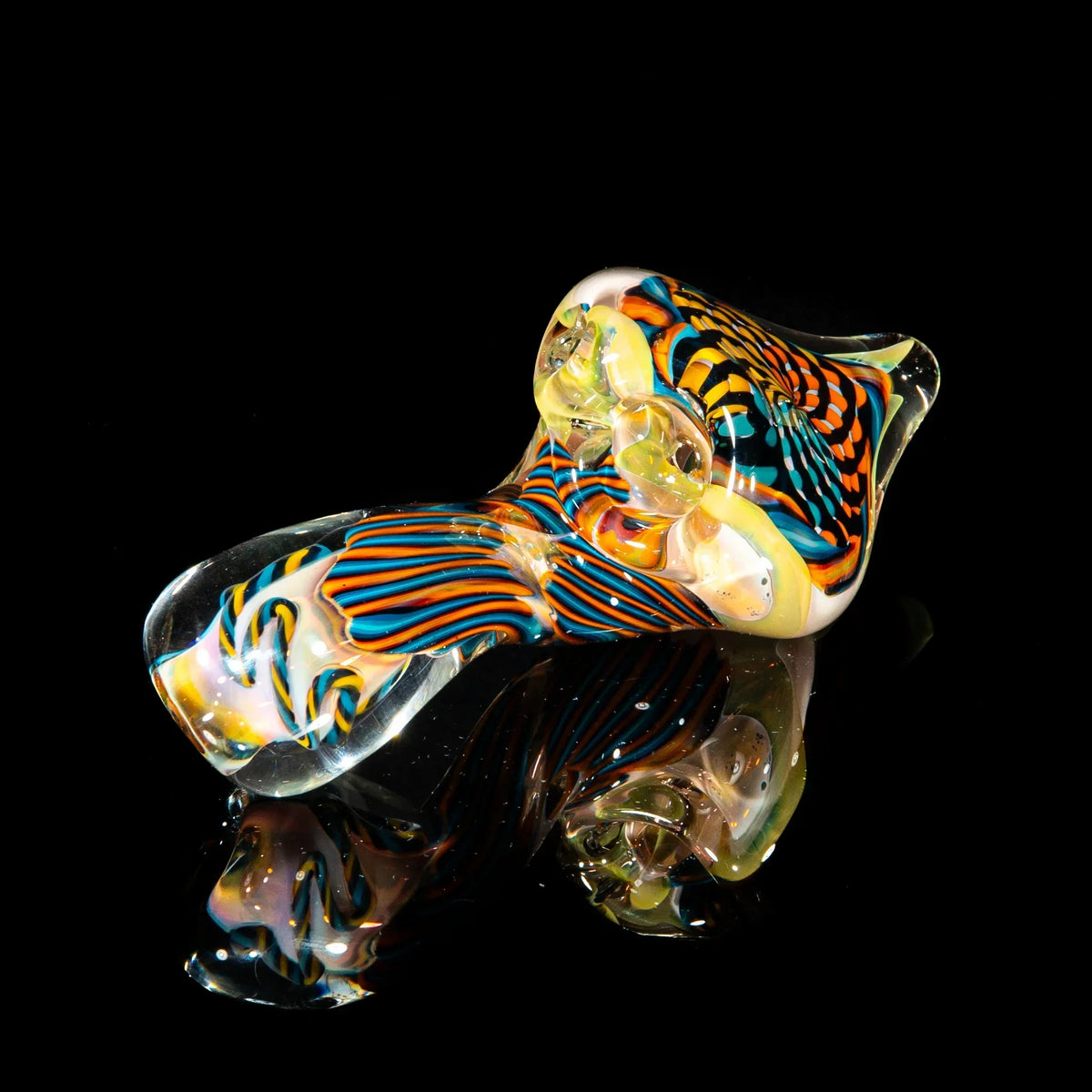 Colorful hand-blown reticello glass sherlock pipe with teal, orange, and yellow patterns