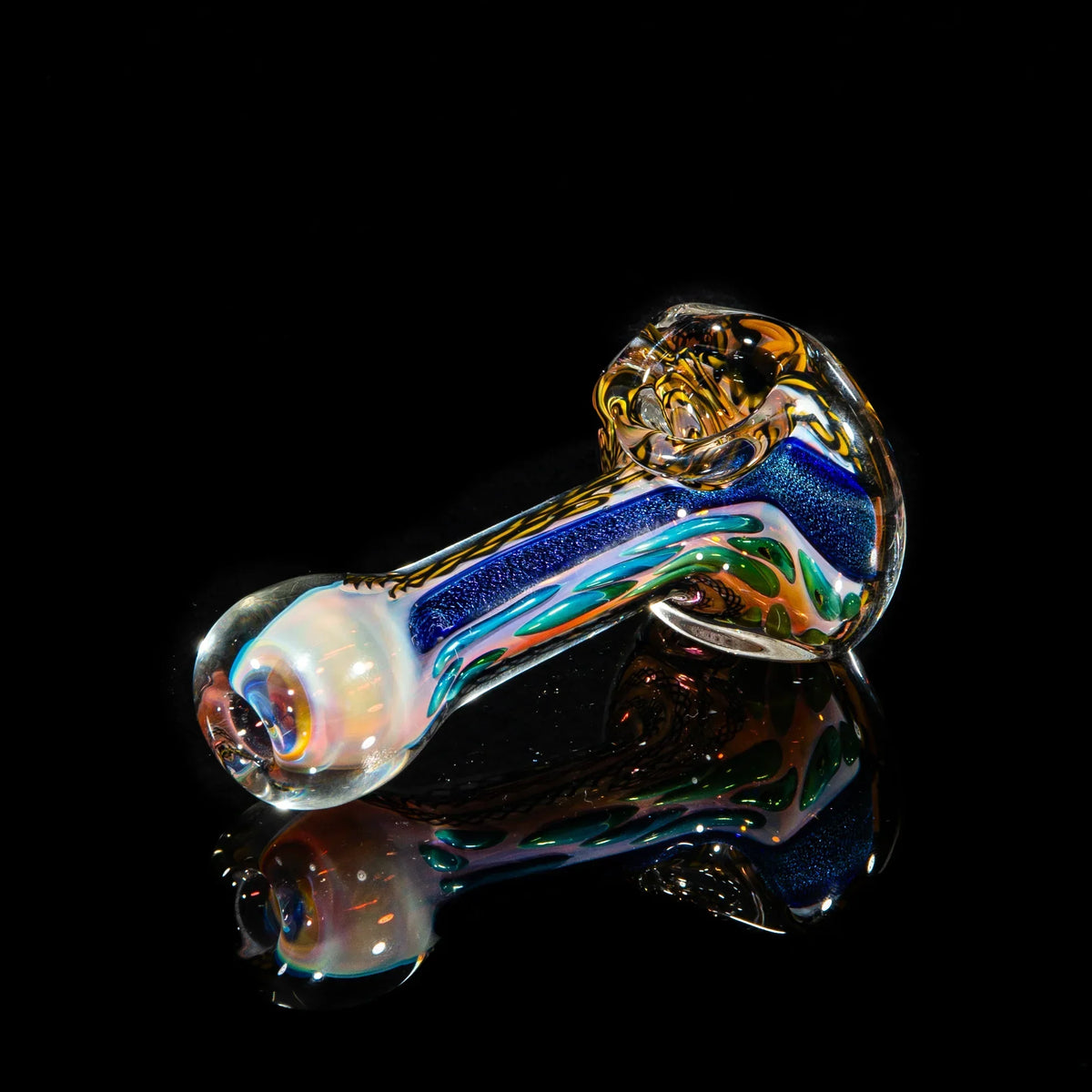 Colorful glass hand pipe with yellow, blue, and green dichroic strip detail on black background.