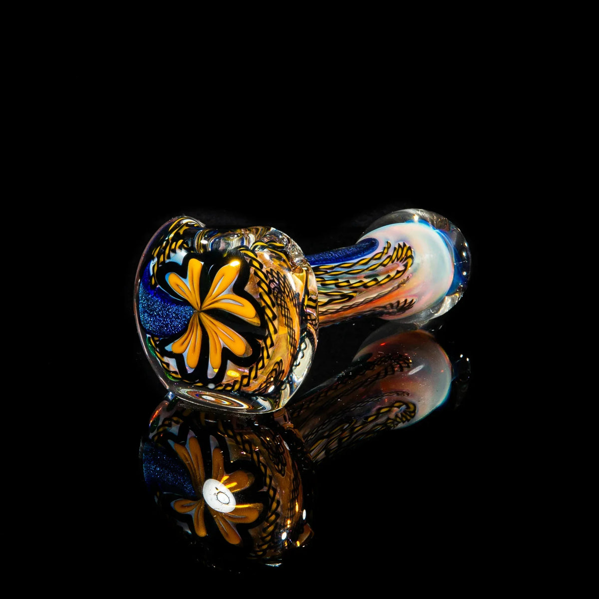 Handblown glass pipe with yellow and blue dichroic swirl design on black background
