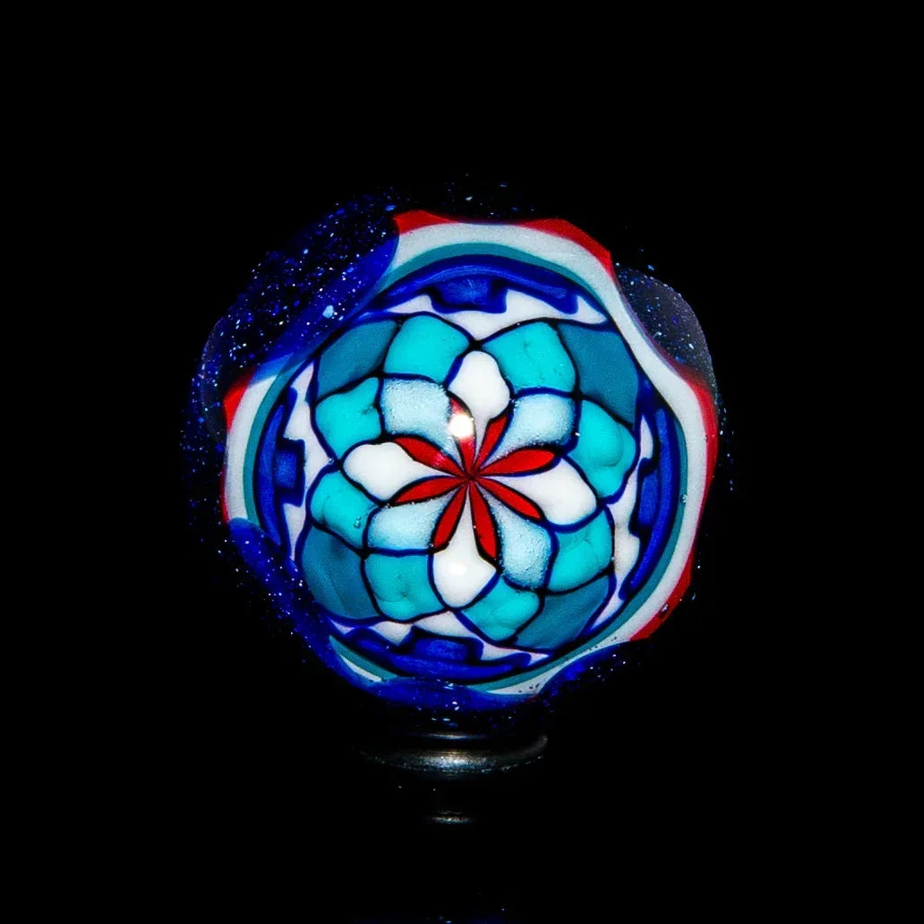 Handcrafted marble with intricate blue, red, and white floral glass design on black background