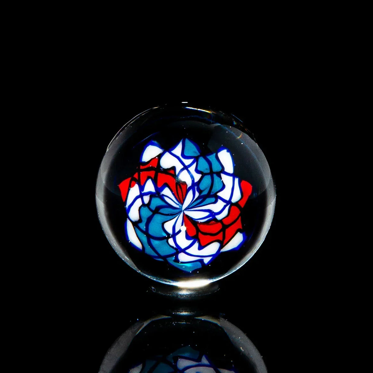 20mm glass marble with intricate red, blue, and white swirl pattern on black background