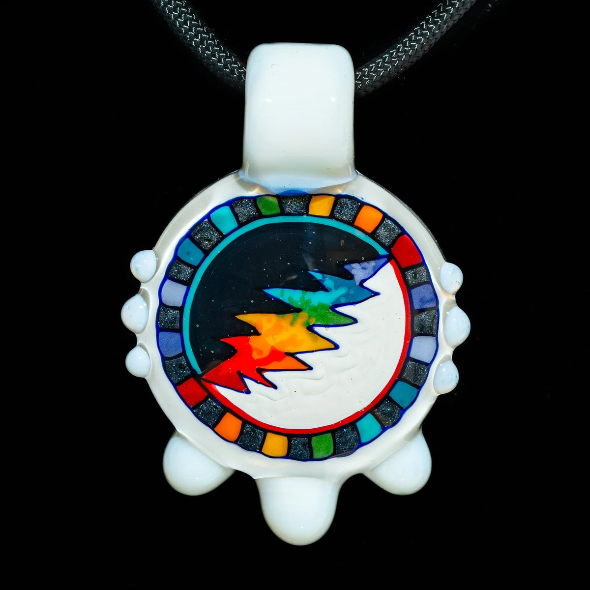 Colorful glass pendant with lightning bolt and rainbow accents on black background