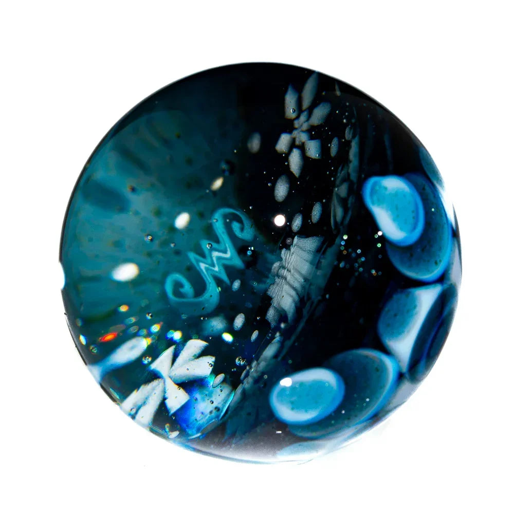 Blue and black blown glass marble with intricate patterns and bubble accents