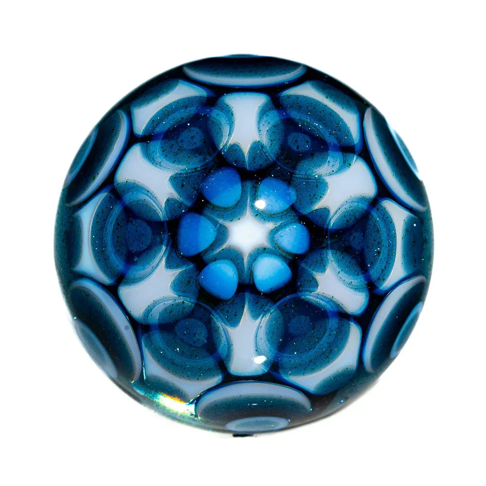 Intricate blue and white patterned glass marble with a kaleidoscopic design, heady glass art