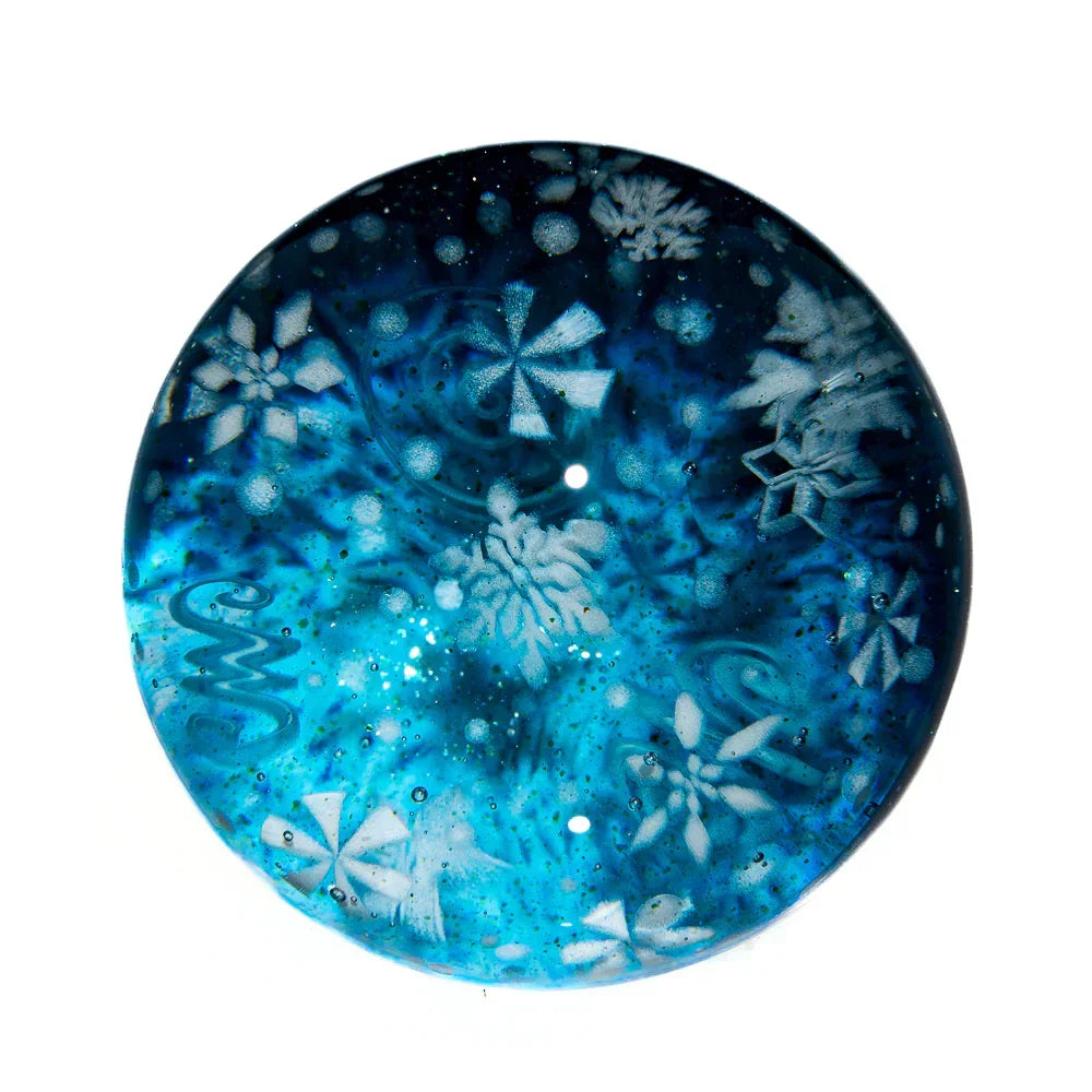 Blue glass carb cap with white snowflake designs and intricate patterns