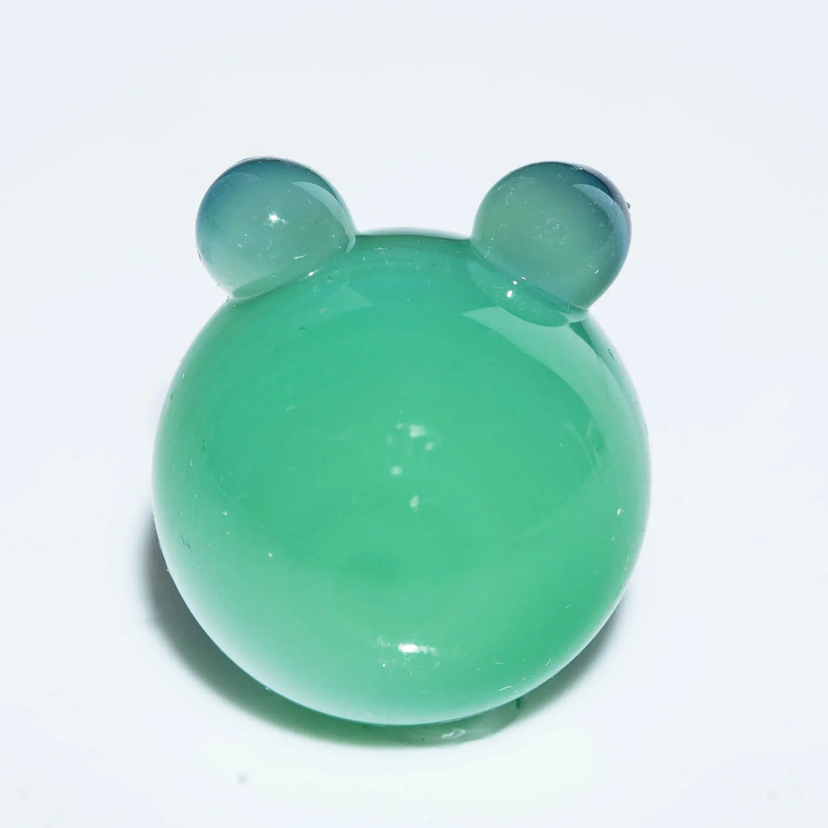 Green glass bubble carb cap with two rounded handles on a white background