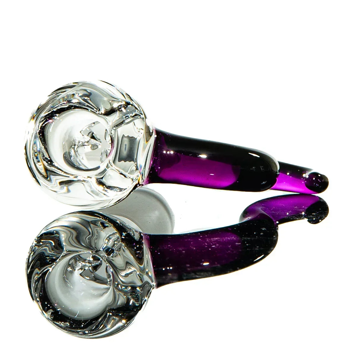 Gold and amethyst swirled glass spoon pipe for smoking, reflected on white surface