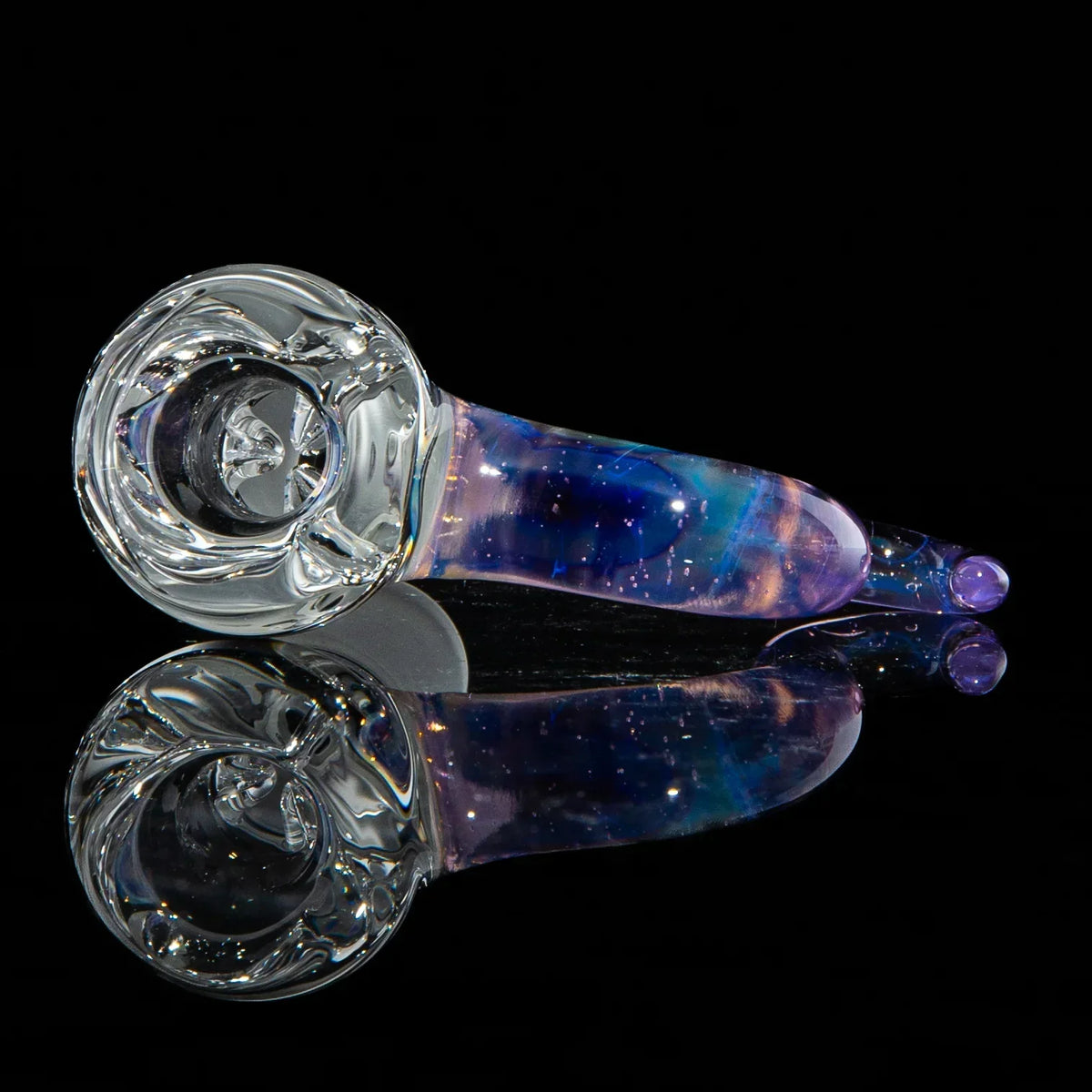 Colorful glass hand pipe with clear bowl and swirled blue and purple accents on black background.