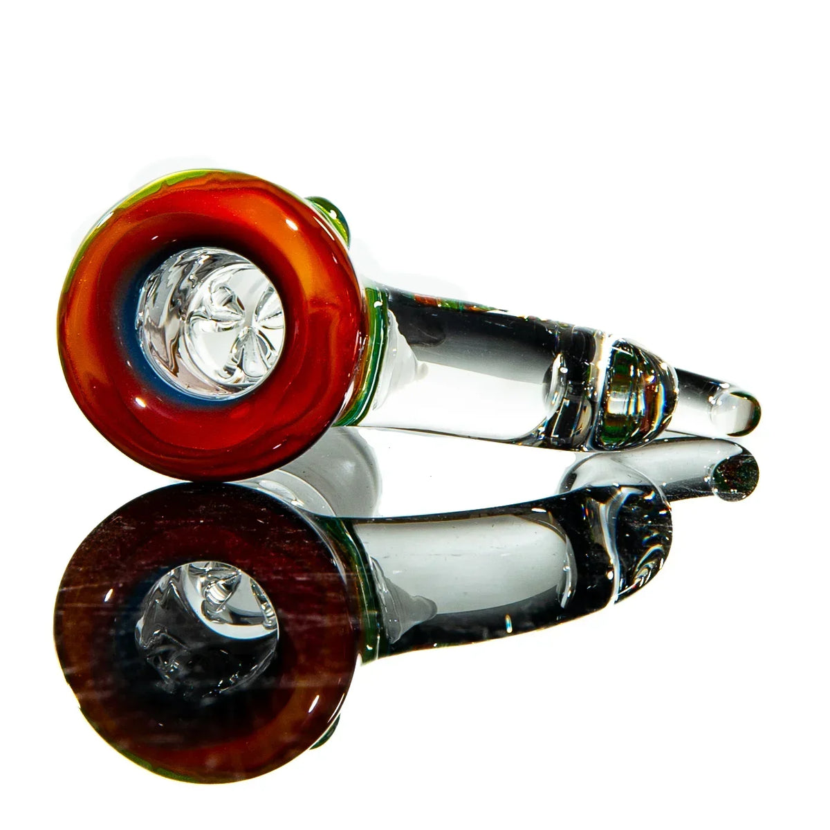 Hand-blown glass pipe with colorful red and green rim, shown on reflective surface.