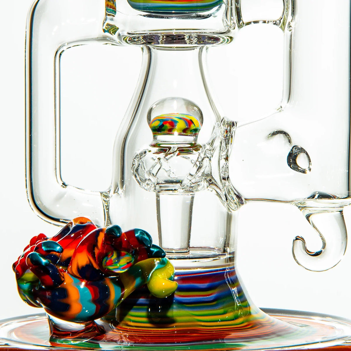 Heady glass water pipe with vibrant rainbow accents and intricate clear glasswork