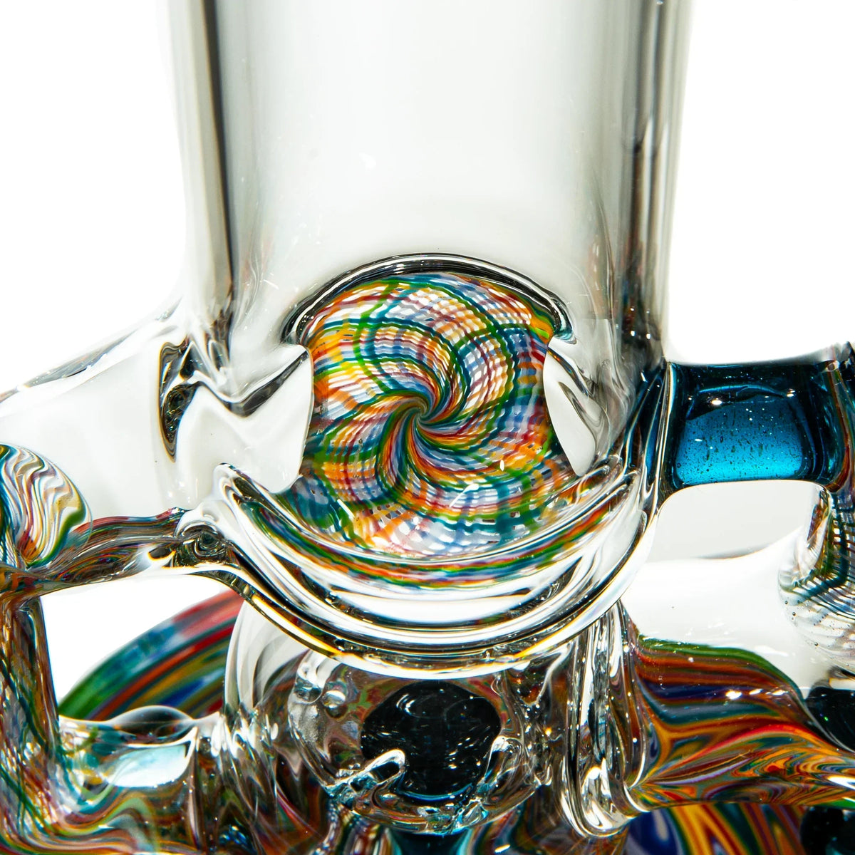 Close-up of intricate heady glass art with colorful spiral pattern and clear glass accents.