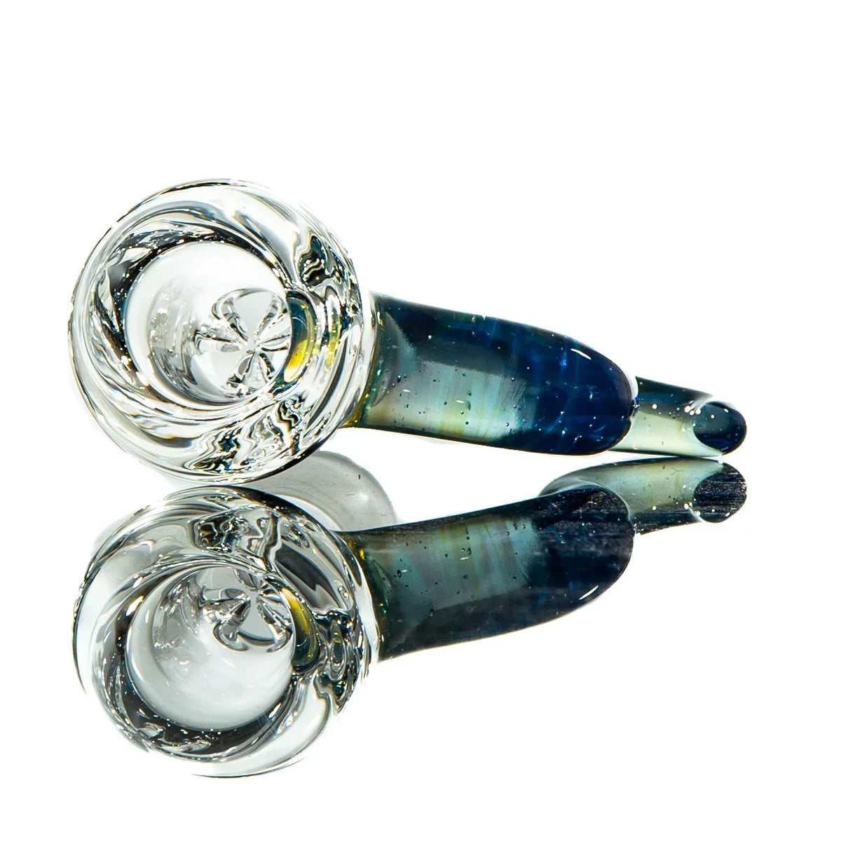 Handblown glass spoon pipe with blue and green hues, displayed on reflective surface