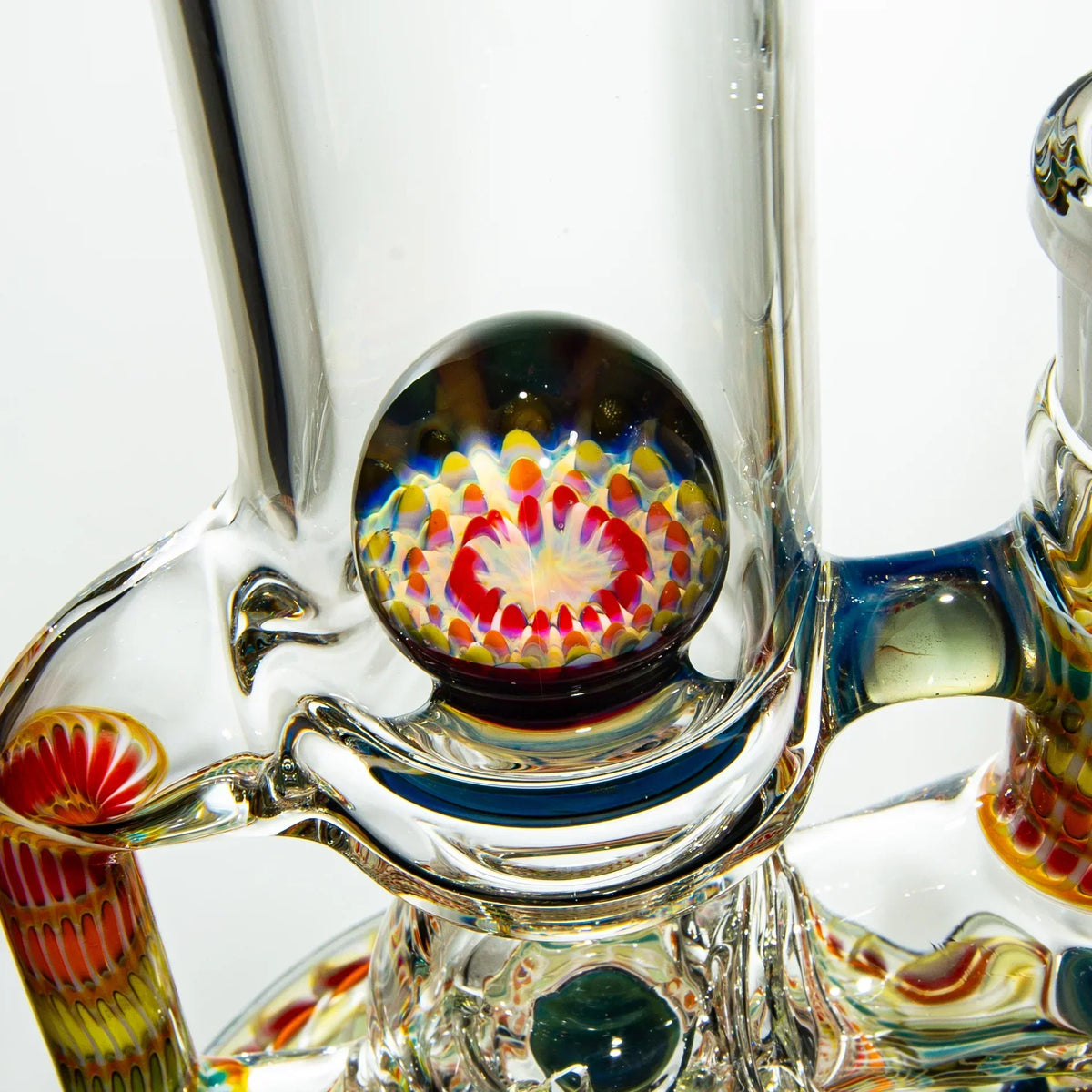 Close-up of intricate heady glass water pipe with colorful marbled accents and detailed patterns.