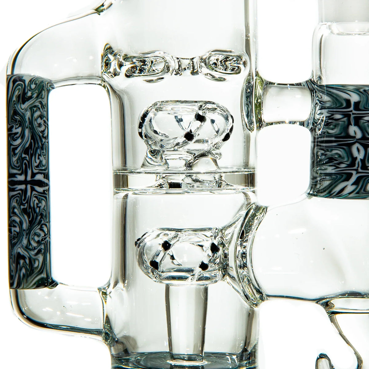 Detailed close-up of an artistic glass water pipe with intricate swirled patterns and percolators.