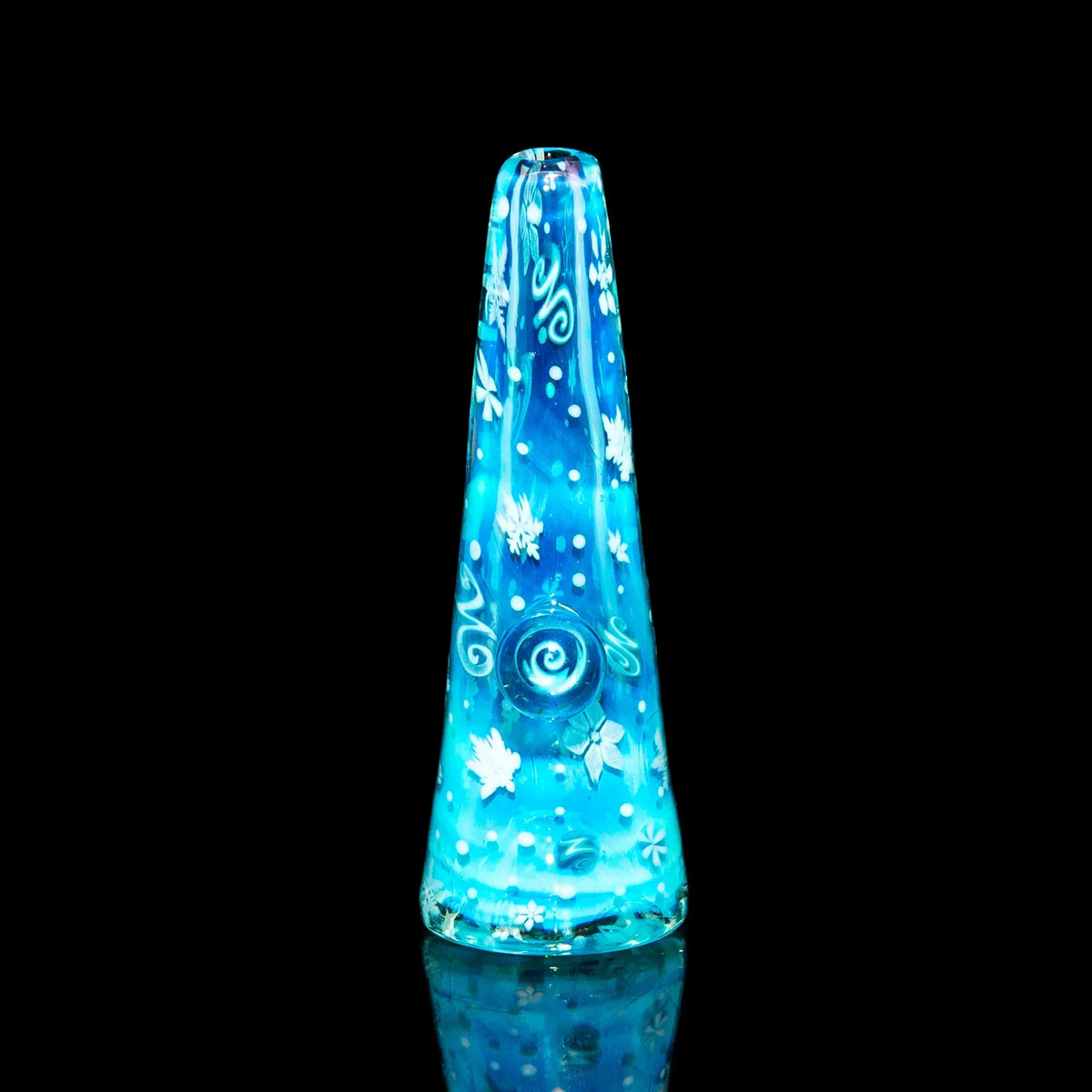 Blue glass chillum pipe with white snowflake and swirl designs on black background