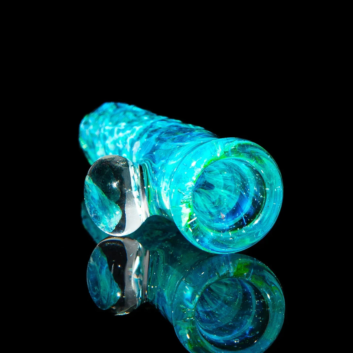 Colorful blue glass chillum pipe with ice cave design on a reflective black surface