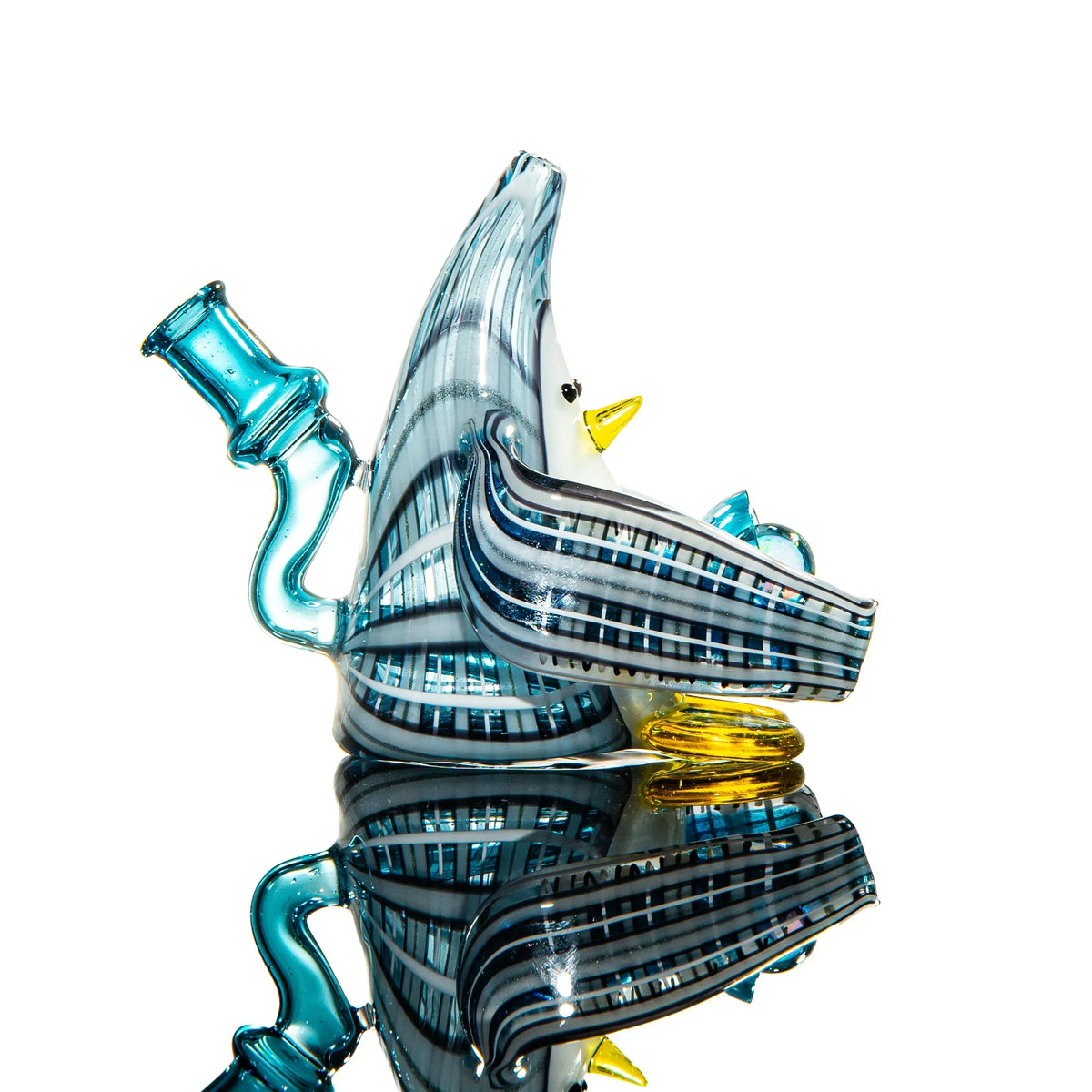 Hand-blown glass penguin-shaped water pipe with blue, yellow, and black accents on white background.