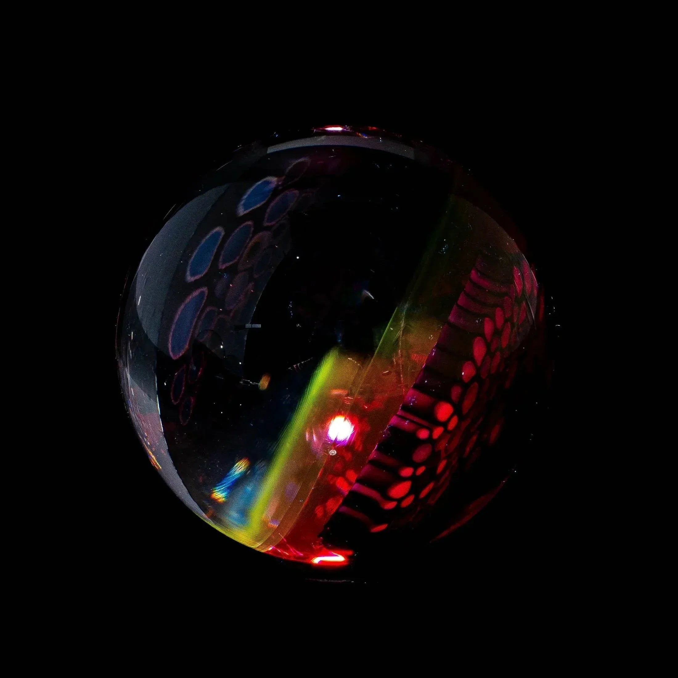 Heady glass marble with colorful patterns and abstract designs on a black background
