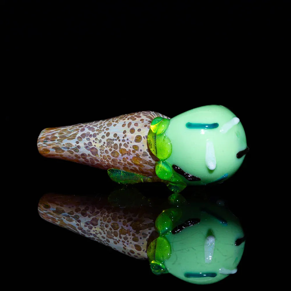 Handcrafted glass spoon pipe shaped like a pistachio ice cream cone on black background