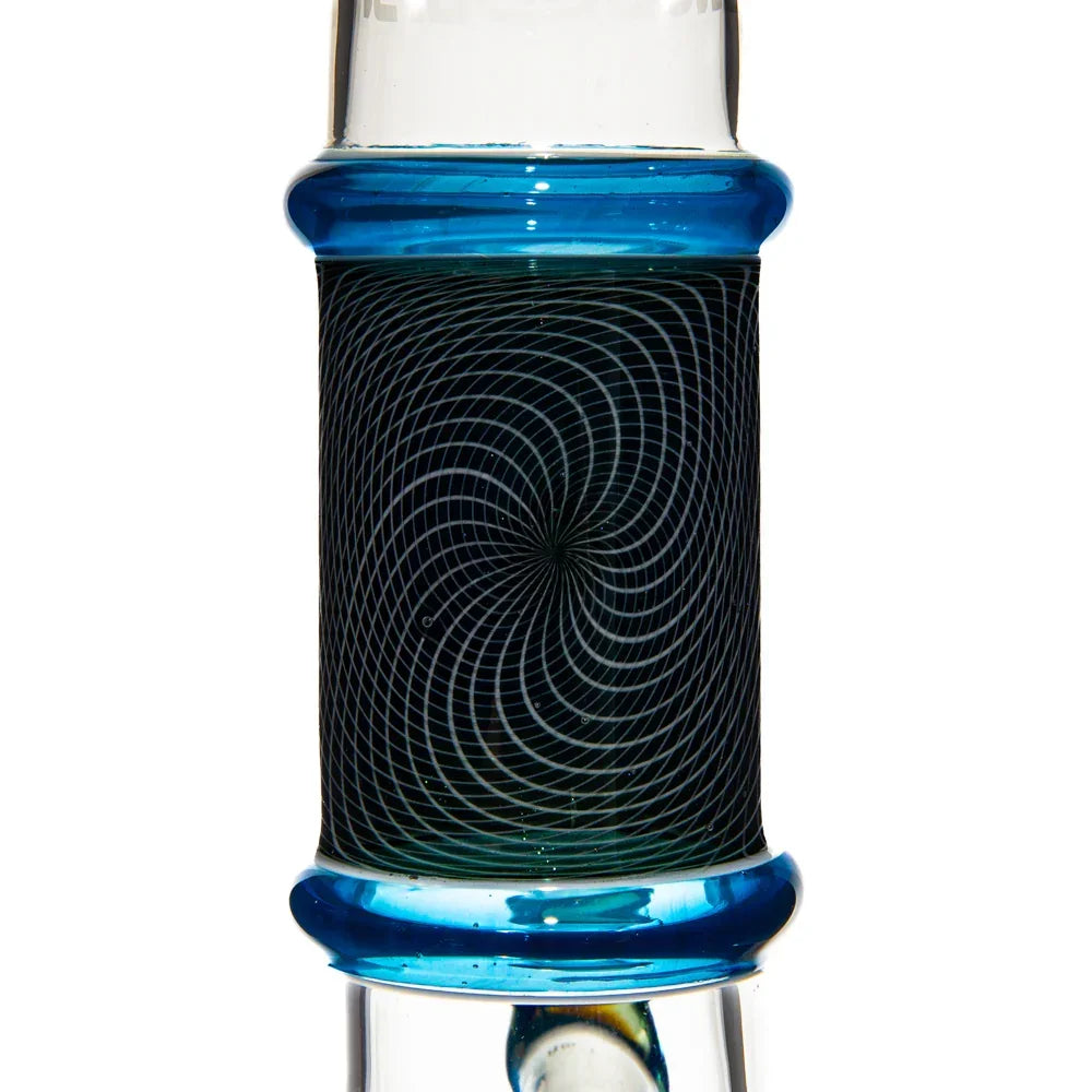 Close-up of blue glass beaker with intricate spiral pattern on the neck
