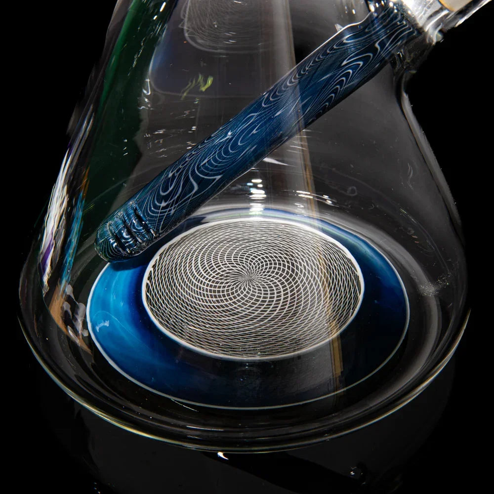 Close-up of a blue slyme worked beaker glass water pipe with spiral pattern base