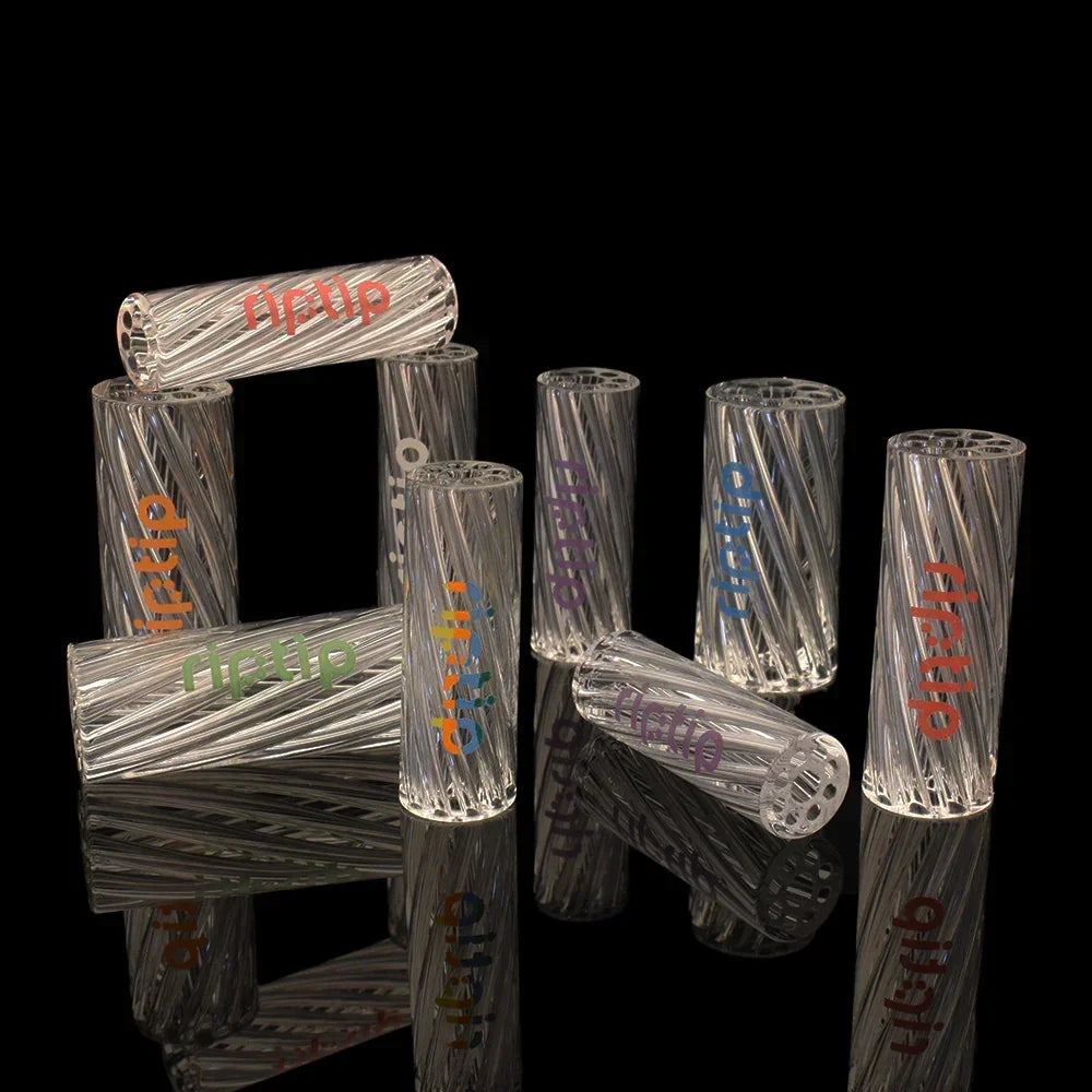 Assorted clear glass filter tips with colorful 'riptip' text, displayed on black surface.