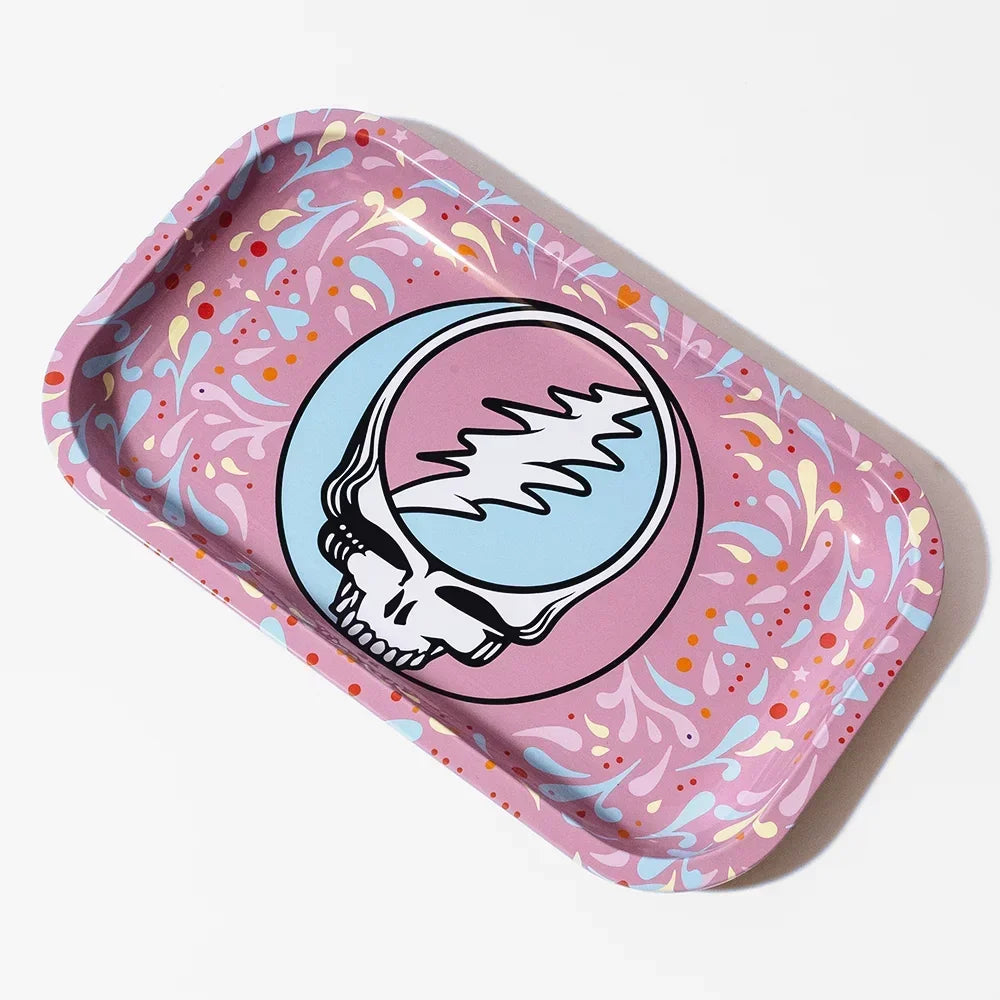 Metal rolling tray with psychedelic skull graphic and pastel splatter design on pink background