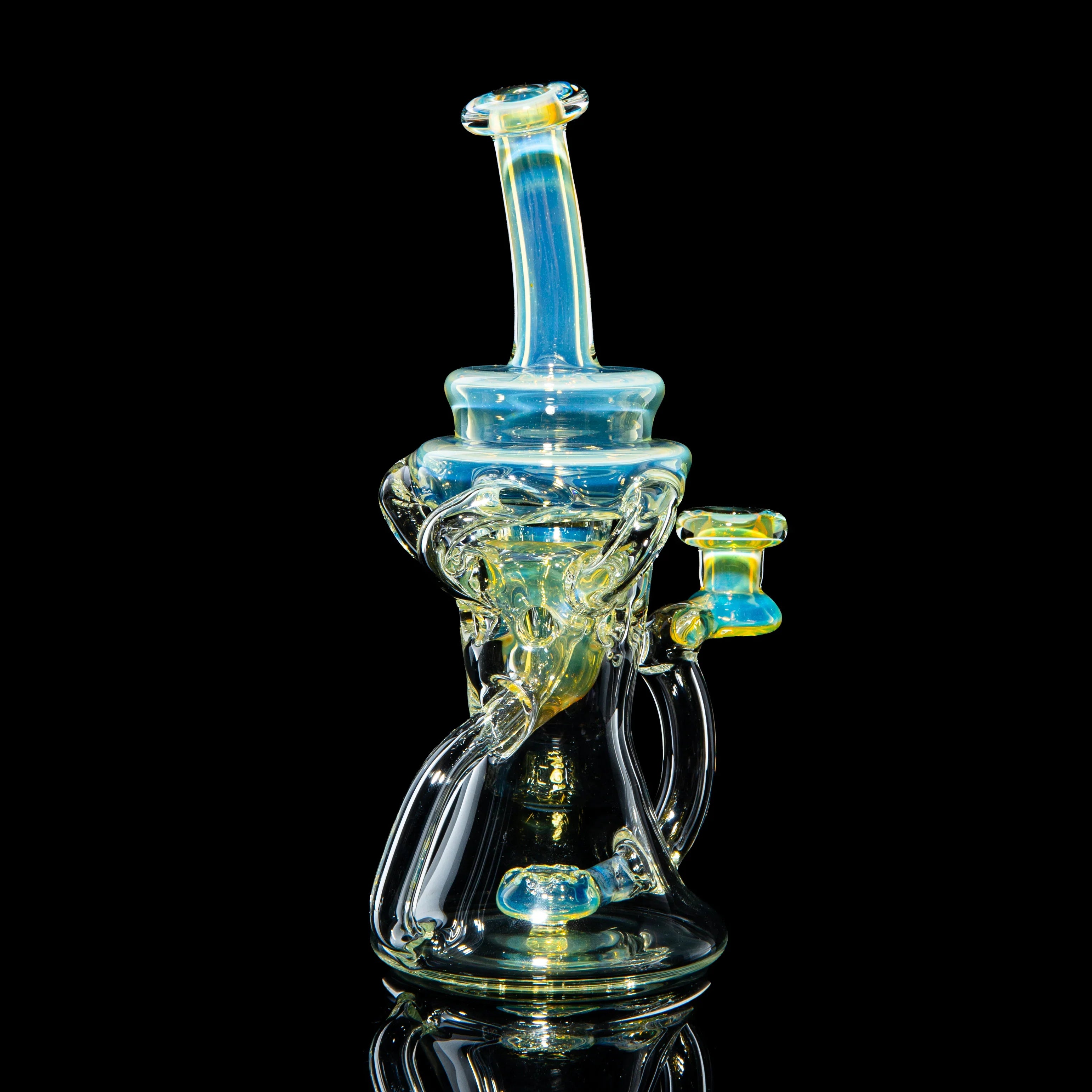 Intricate heady glass water pipe with blue and yellow accents on black background