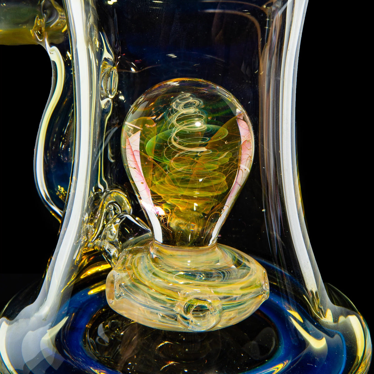 Close-up of a hand-blown glass water pipe with intricate swirling designs and colorful details