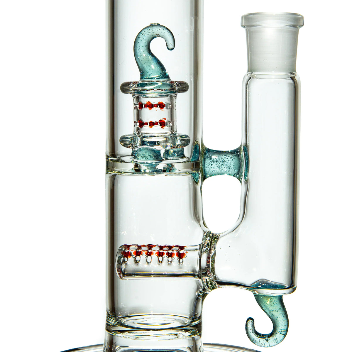Close-up of clear glass water pipe with blue hooks and red accent percolators